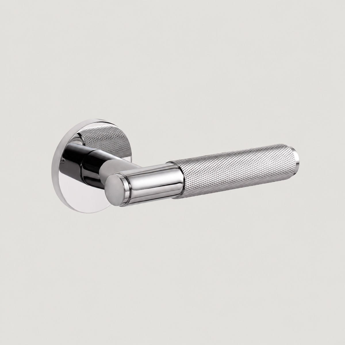 Trama solid brass door lever in polished nickel with a diamond-knurled grip and round rose