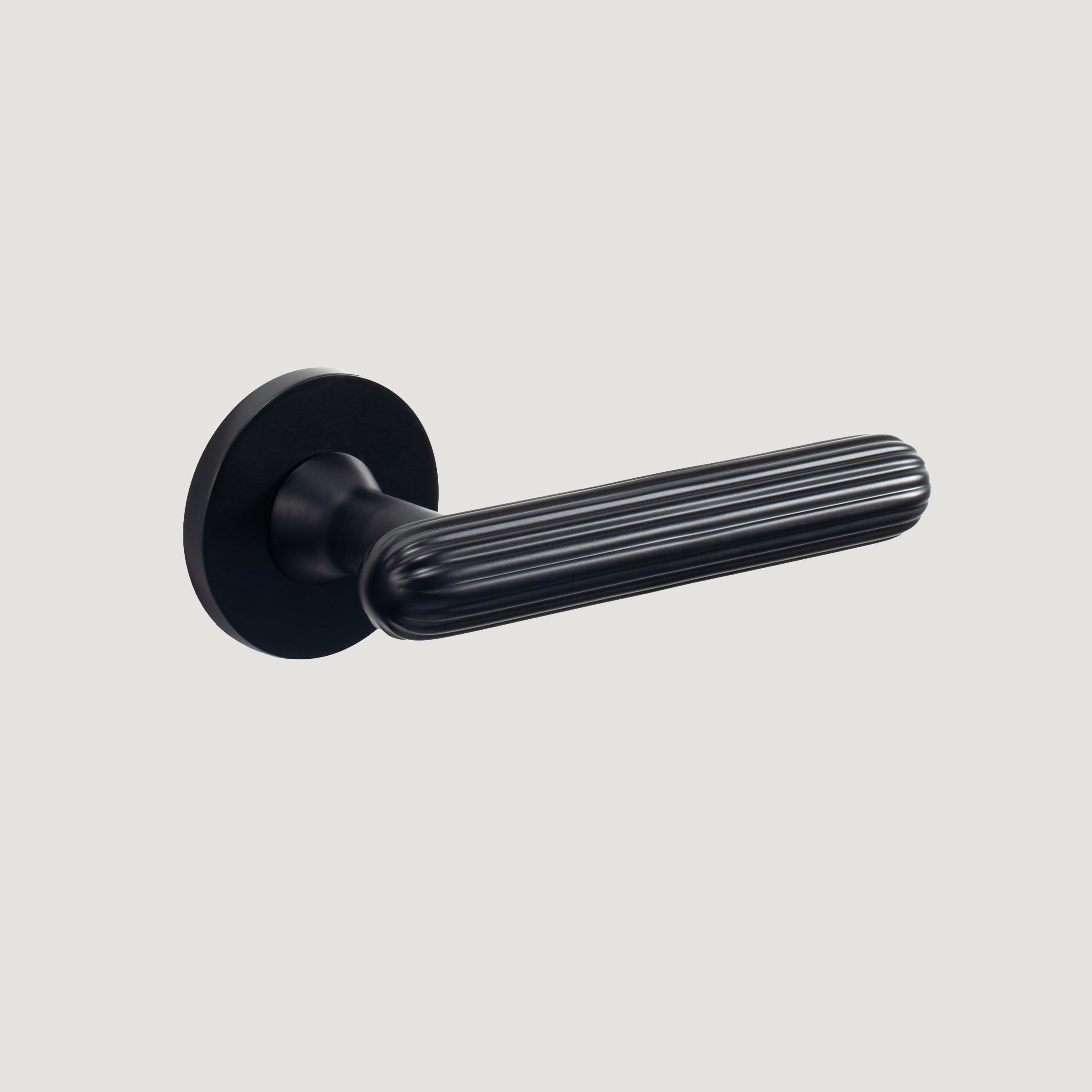 Onda solid brass door lever with softly fluted grip and rounded tip, Matte Black, Bergamo Design
