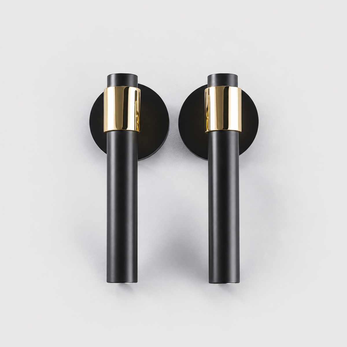 Duale black door lever pair with polished brass collars and black round roses