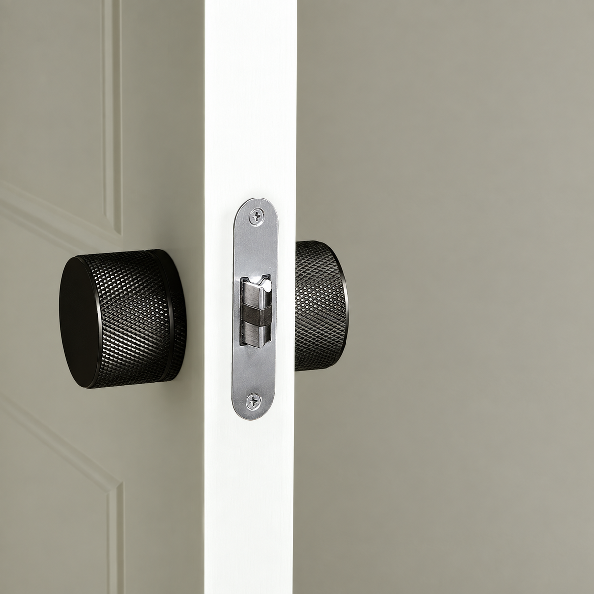 Pomello black knurled door knobs installed on a door