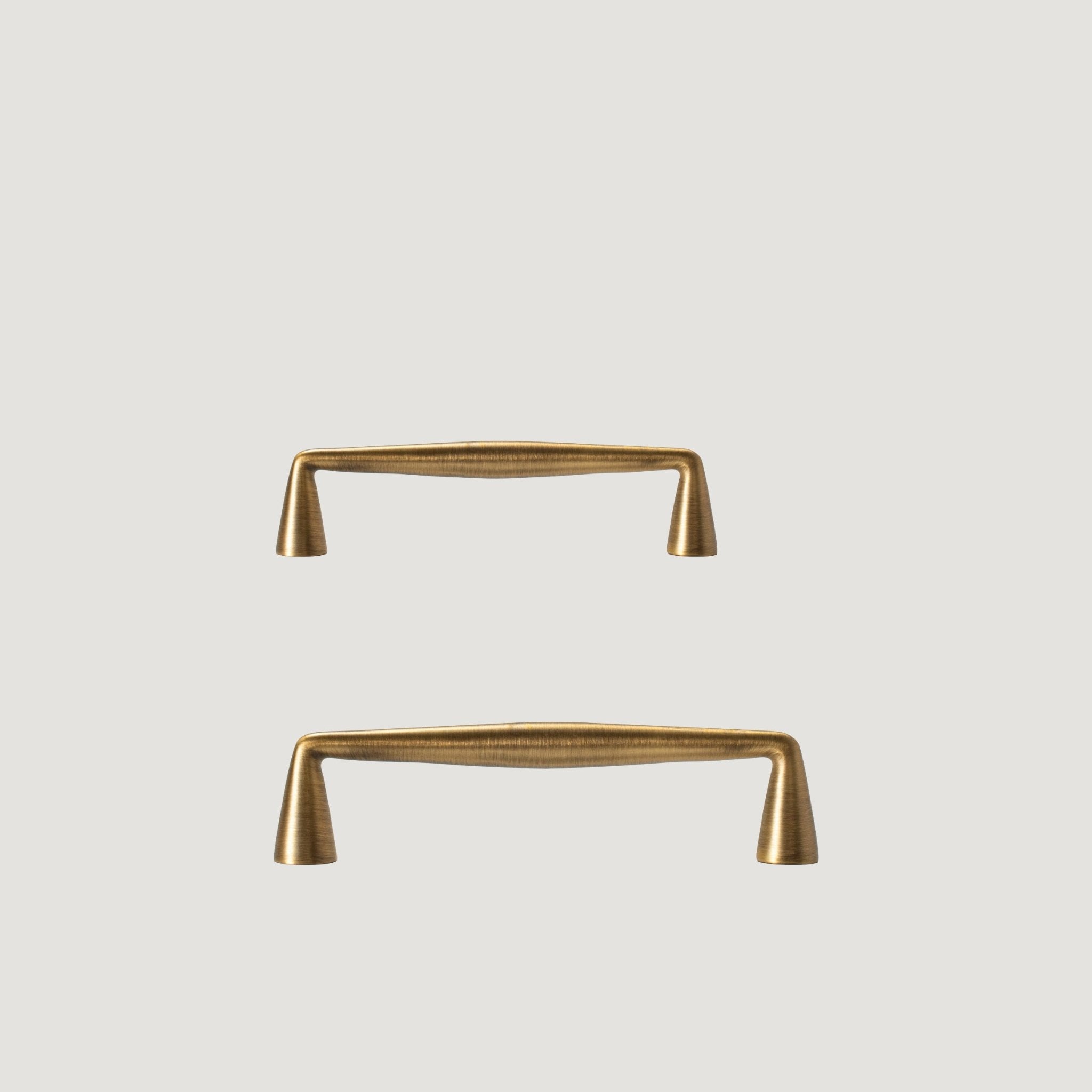Borgo solid brass cabinet handle with continuous flowing pull and tapered feet, Antique Brass, Bergamo Design