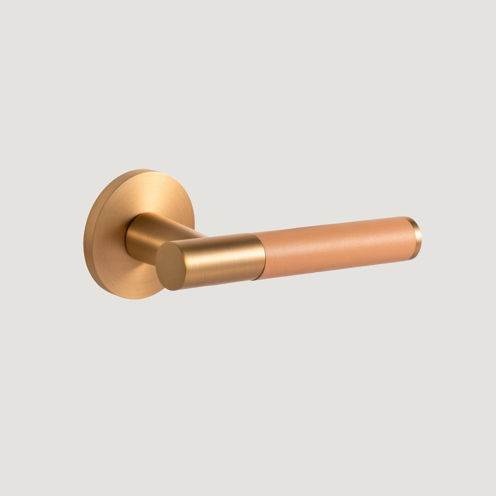 Cavallo solid brass door lever with brushed Brass proud-standing rose and hand-stitched beige leather grip, Bergamo Design