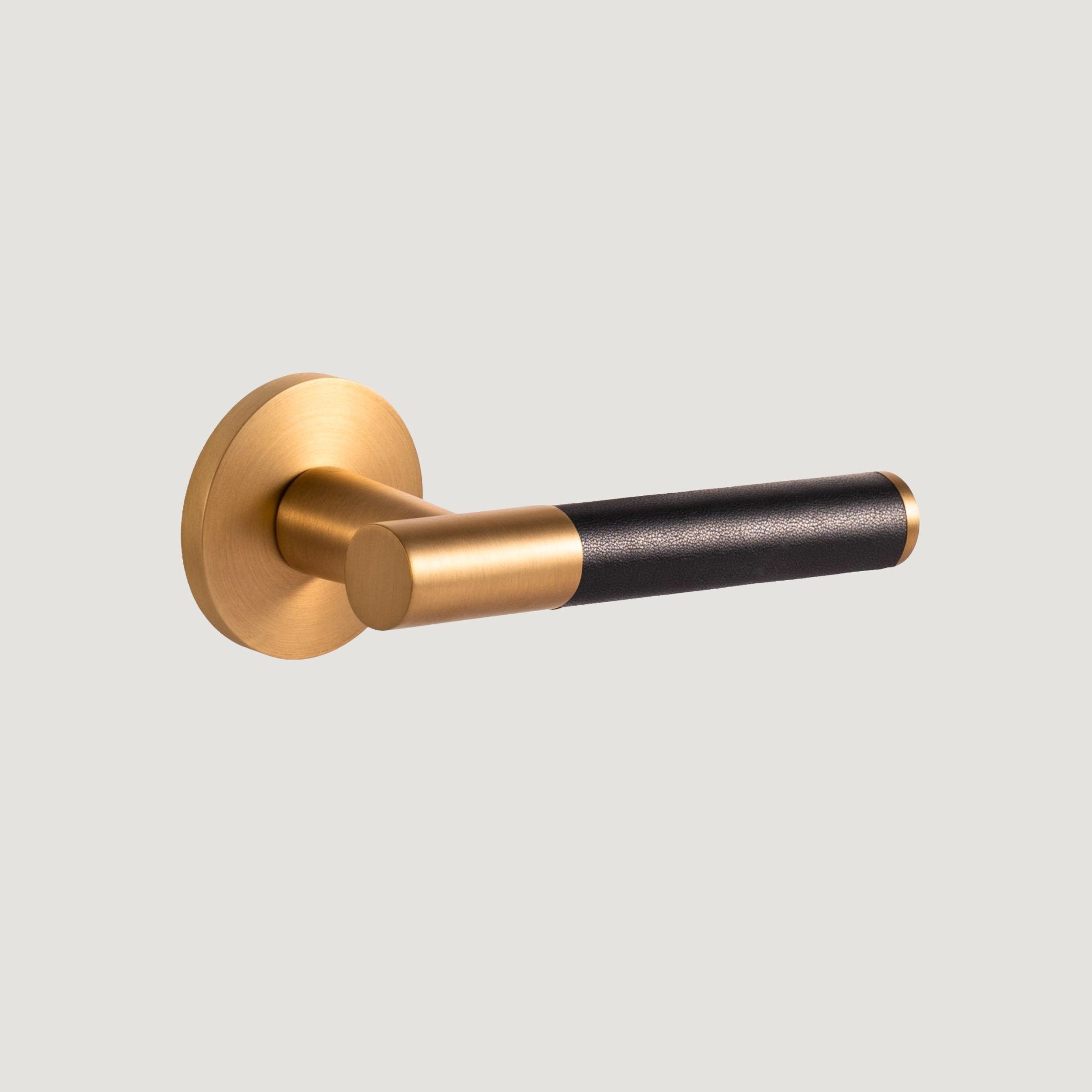 Cavallo solid brass door lever with brushed Brass proud-standing rose and hand-stitched black leather grip — Bergamo Design
